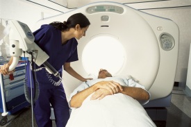 Technician preparing patient for a CT scan
