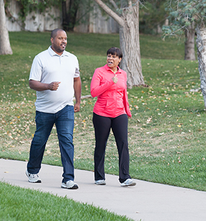 Man and woman walking in park.