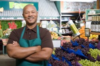 Healthy-looking African-American man standing in the produce section of a market